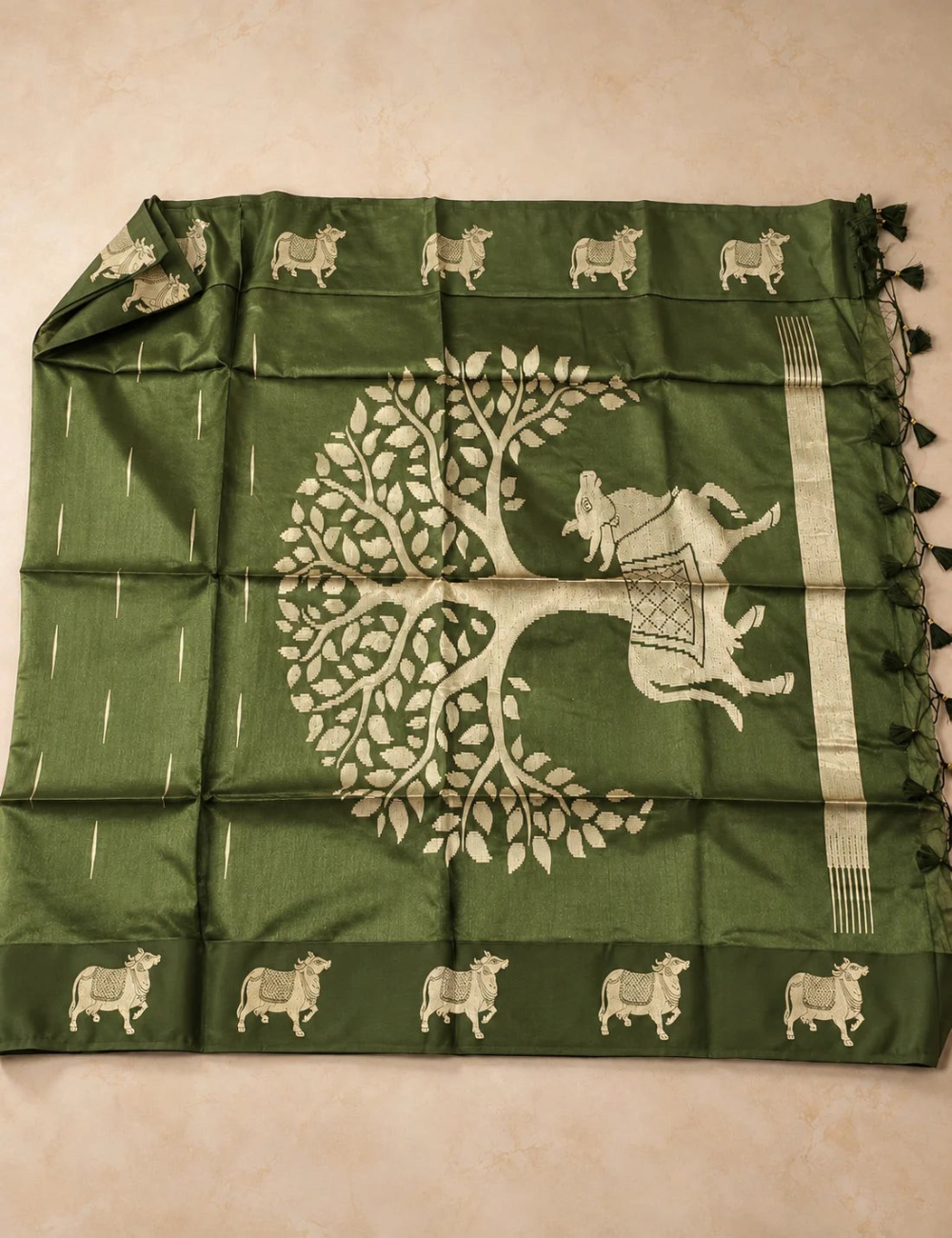House Of Paramya olive green raw tussar silk saree featuring intricate gold zari Pichwai cow and tree motifs.