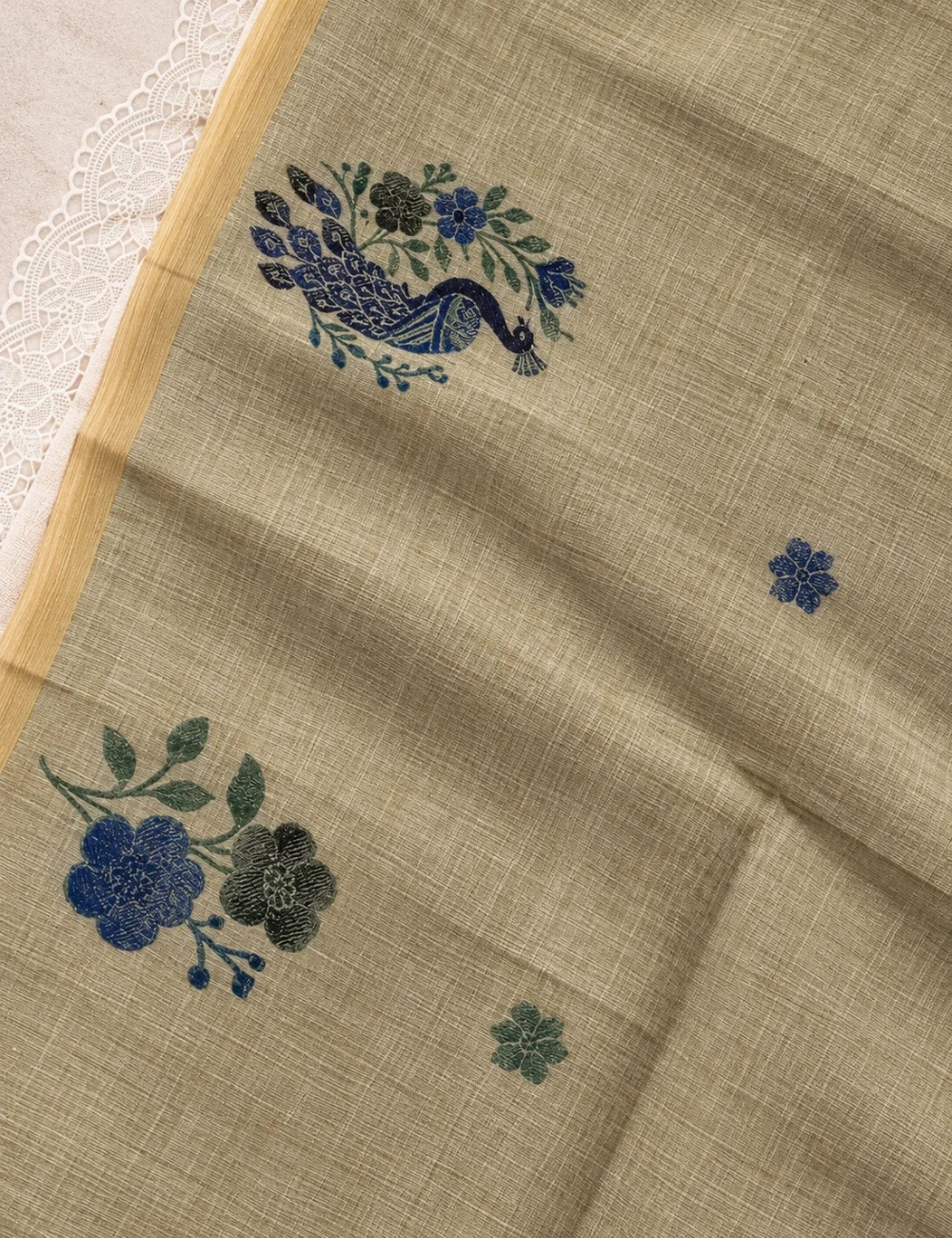 House Of Paramya olive green Munga cotton saree featuring woven blue peacock and floral motifs with a gold border.