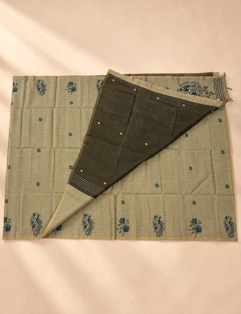 House Of Paramya olive green Munga cotton saree with blue woven peacock and floral motifs and a contrast blouse piece.