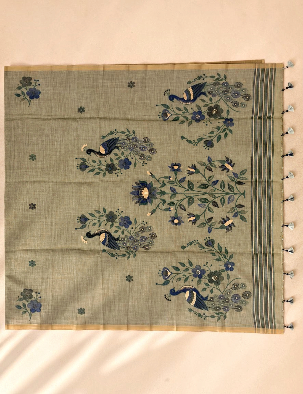 House Of Paramya olive green Munga cotton saree featuring woven peacock and floral motifs with a striped pallu and tassels