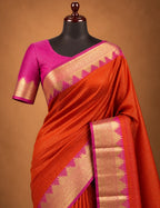 House Of Paramya orange Mysore crepe silk saree with gold zari temple border, pink zigzag edge, and pink pallu.