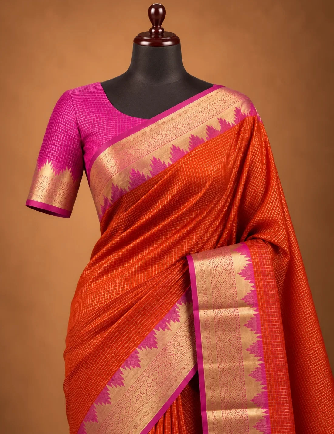 House Of Paramya orange Mysore crepe silk saree with gold zari temple border, pink zigzag edge, and pink pallu.