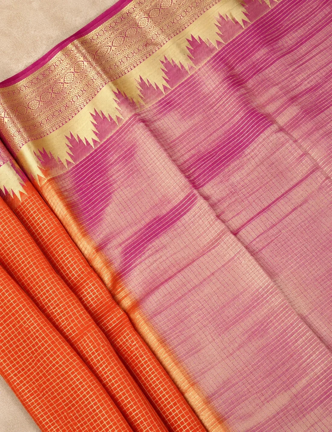 House Of Paramya orange Mysore crepe silk saree featuring a gold zari temple border and a contrasting pink pallu.