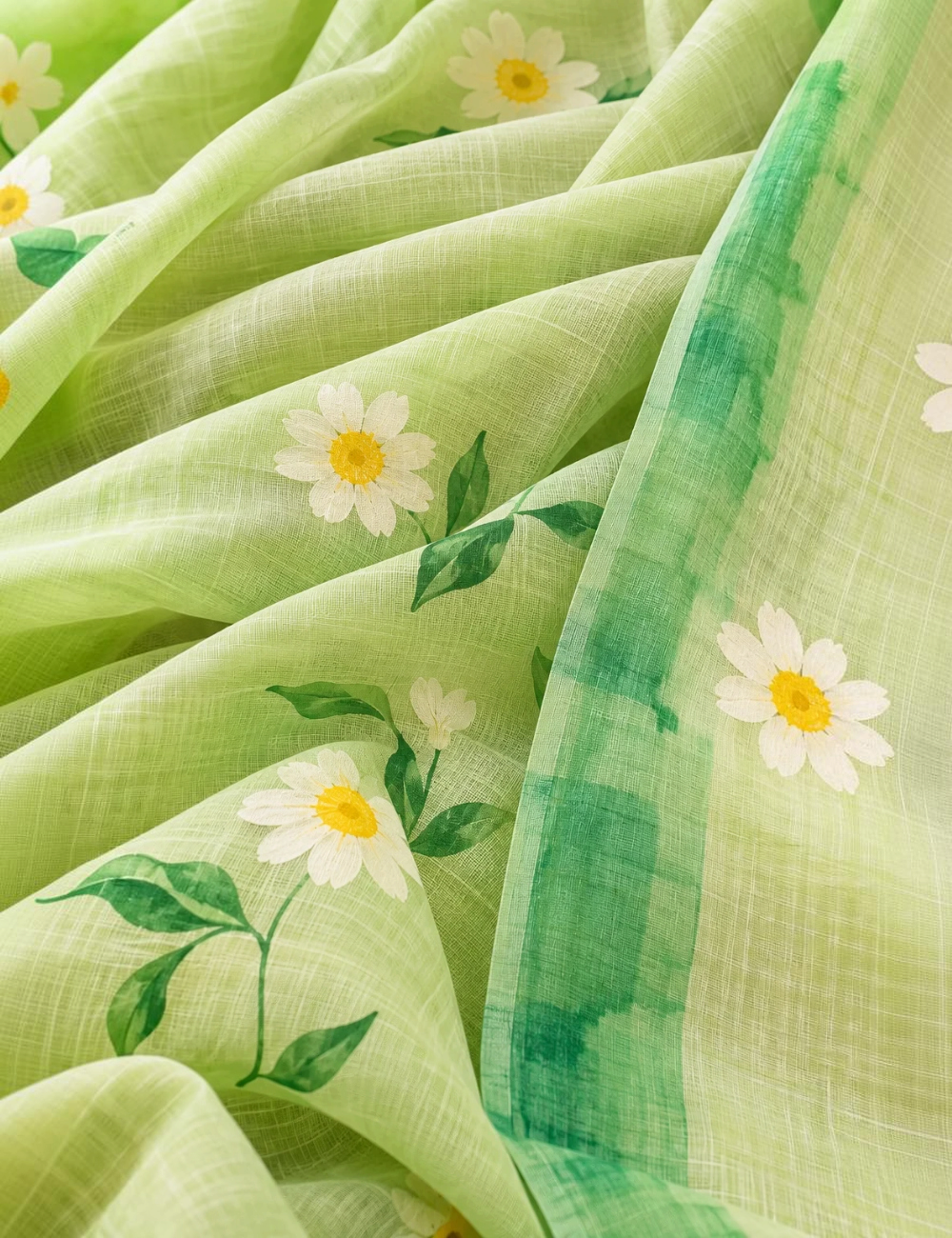 House Of Paramya pastel green linen cotton saree featuring a white and yellow daisy floral print and dark green border