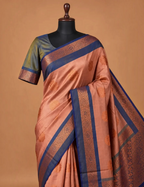 House Of Paramya soft silk saree in sapota peach with royal blue border, copper zari floral motifs, and teal blouse