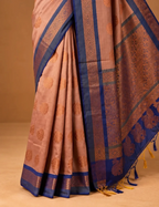House Of Paramya sapota peach soft silk saree featuring royal blue borders and intricate copper zari floral motifs.