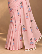 House Of Paramya powder pink linen cotton saree featuring a whimsical doll print and a delicate gold striped border.