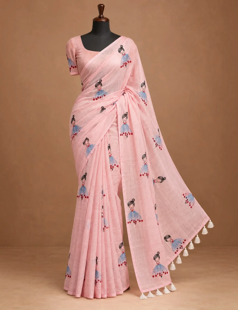 House Of Paramya powder pink linen cotton saree featuring a whimsical doll print and a delicate gold striped border.