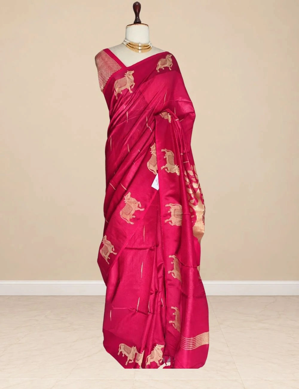 House Of Paramya raw tussar silk saree in deep pink with gold zari Pichwai cow motifs on a mannequin