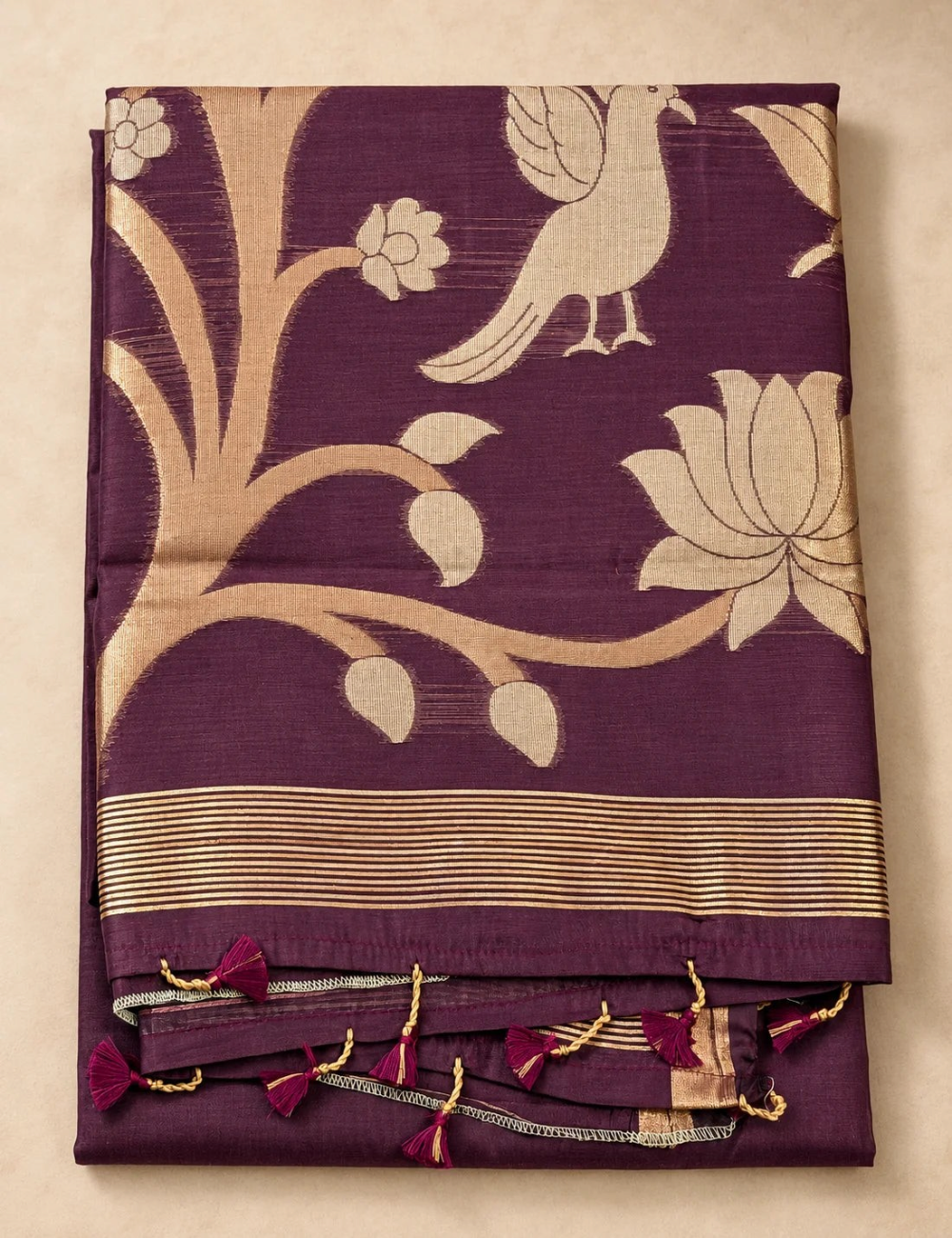 House Of Paramya plum raw tussar cotton saree featuring a gold zari floral tree pallu and decorative tassels