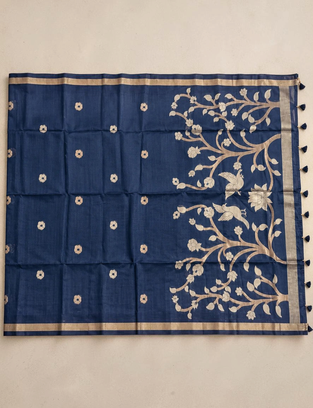 House Of Paramya plum raw tussar cotton saree featuring gold zari floral tree pallu, zari buttis, and tassel details.