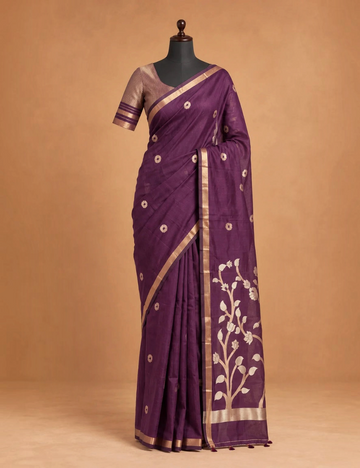 House Of Paramya plum raw tussar cotton saree with gold zari floral pallu, buttis, and a striped blouse piece.