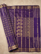 House Of Paramya deep purple Mysore crepe silk saree featuring gold woven checks, mandala motifs, and paisley pallu.