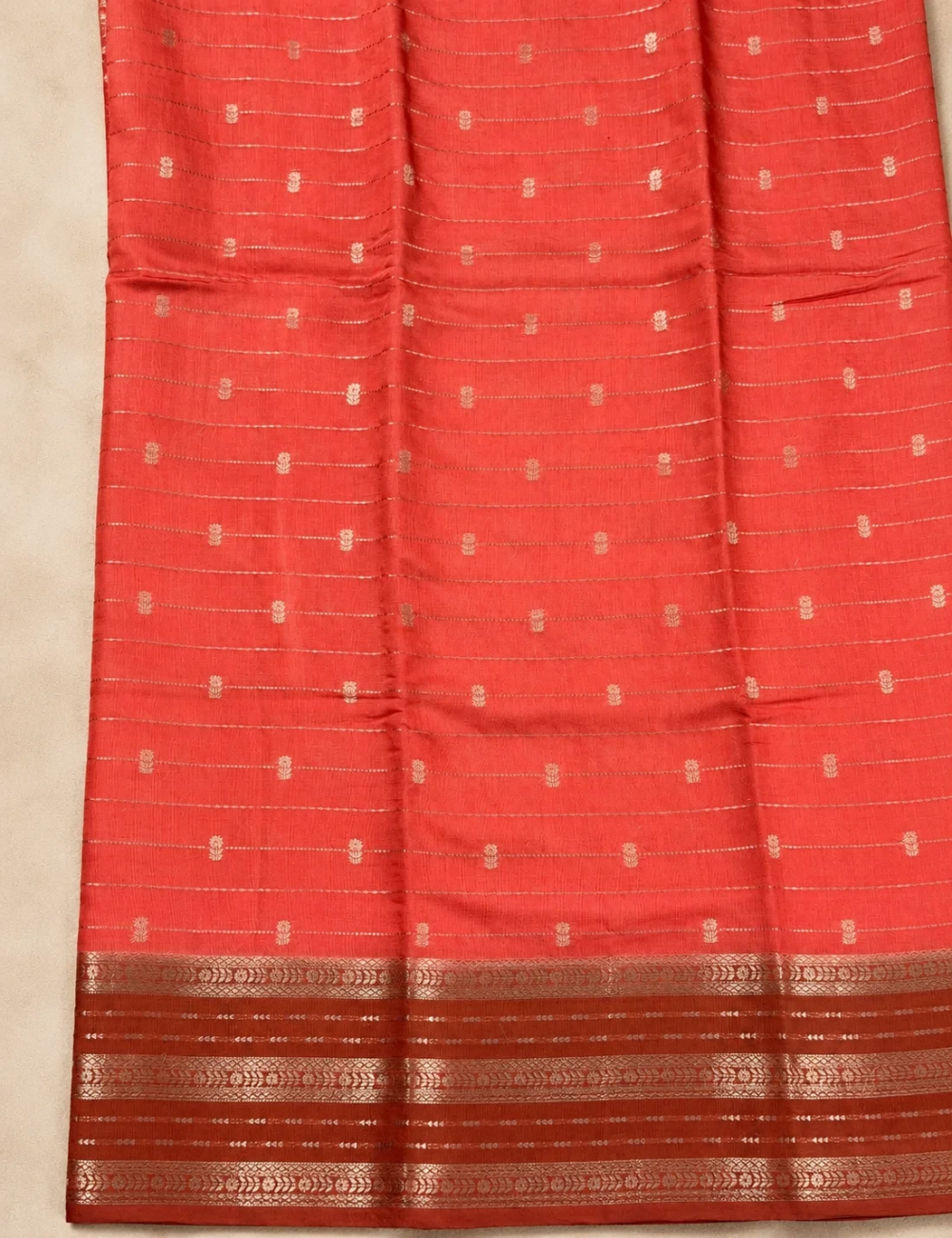 House Of Paramya red Assam cotton saree featuring horizontal gold zari stripes and intricate gold buti weave details.