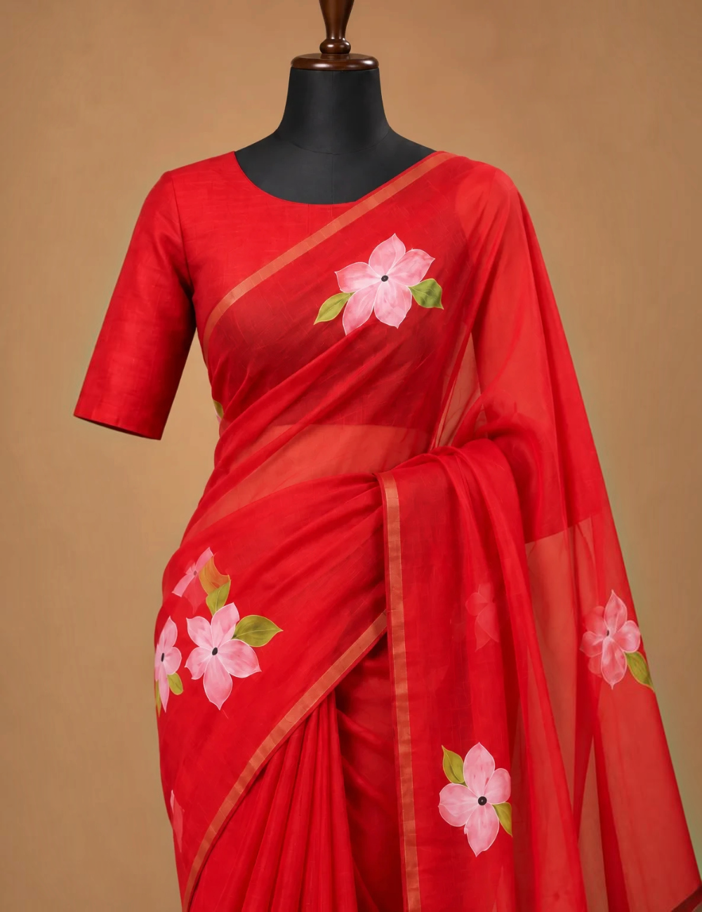 House Of Paramya red linen cotton saree featuring pink floral prints and a delicate gold striped border on a mannequin