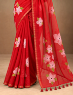 House Of Paramya red linen cotton saree featuring a pink floral print and a shimmering gold striped border