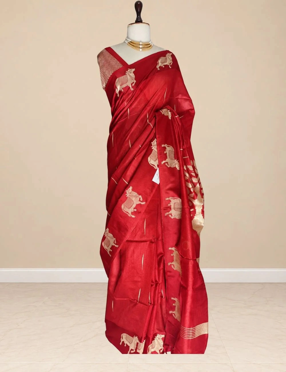 House Of Paramya red raw tussar silk saree featuring woven gold zari Pichwai cow motifs and a matching blouse piece.