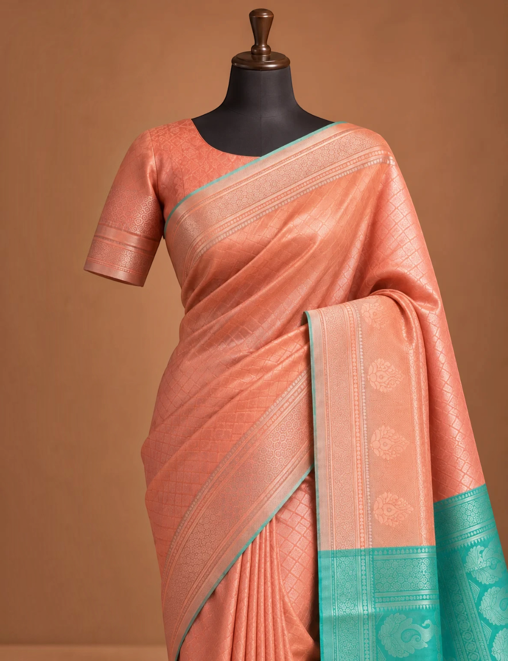 House Of Paramya rose gold and teal Banarasi silk saree featuring a diamond lattice pattern and woven paisley border.