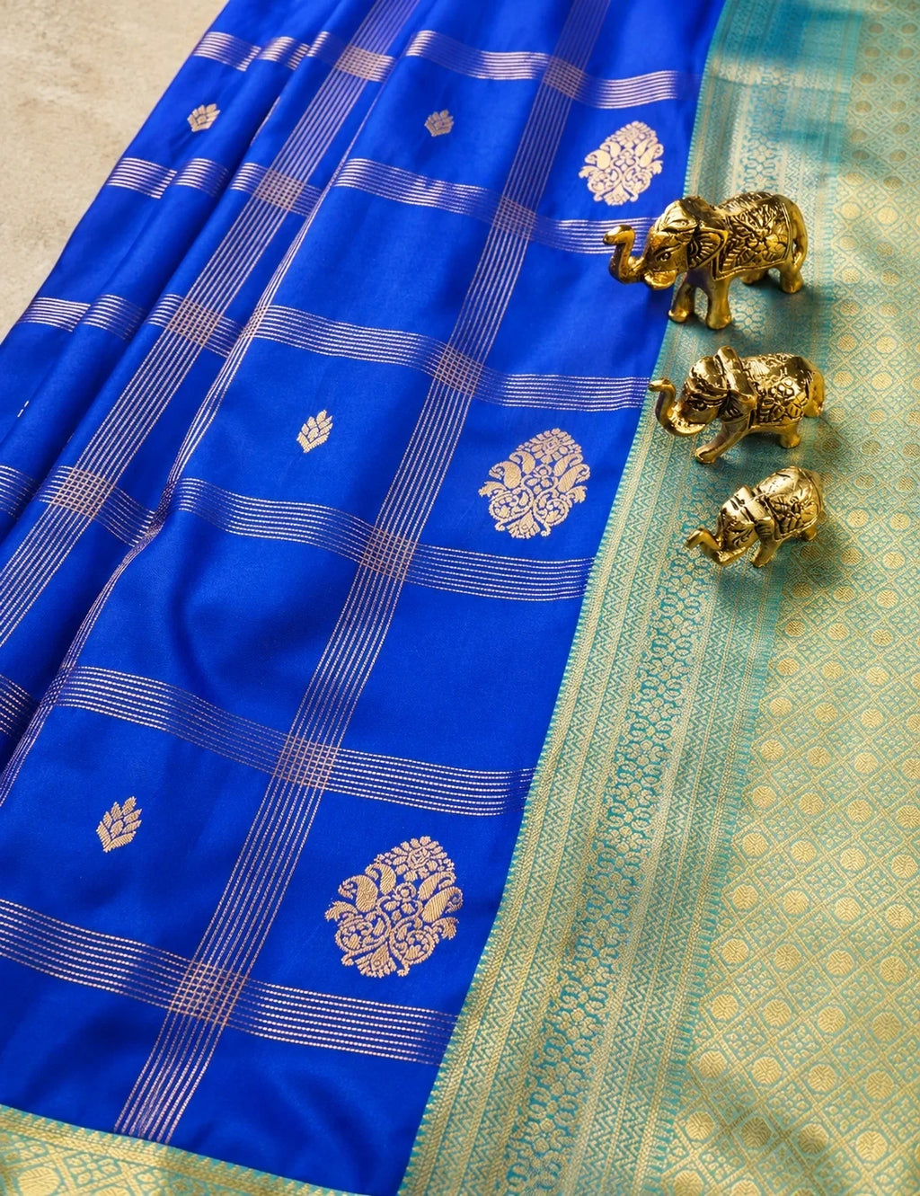 House Of Paramya royal blue semi Kanjivaram silk saree with gold checkered weave, floral butis, and turquoise border