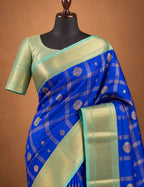 House Of Paramya royal blue semi Kanjivaram silk saree with gold checkered weave, floral butis, and turquoise border.