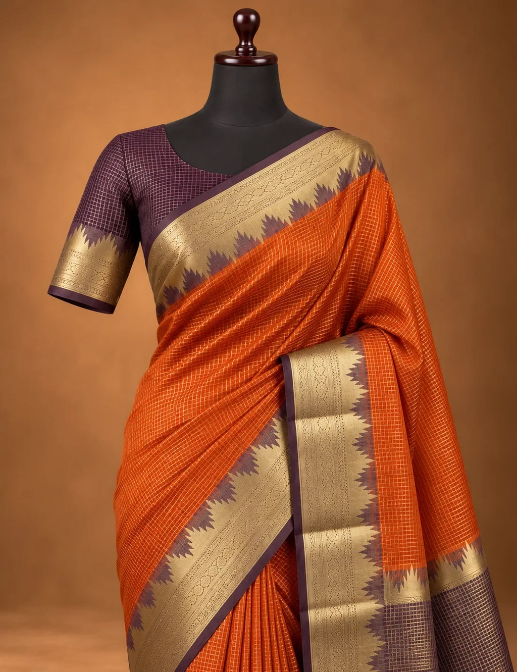 House Of Paramya rust orange Mysore crepe silk saree with a gold zari temple border and charcoal-brown pallu.