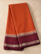 House Of Paramya rust orange Mysore silk saree with a deep brown border and intricate silver zari geometric patterns.