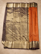 House Of Paramya rust orange Mysore crepe silk saree with a charcoal-brown pallu and gold zari scalloped temple border.