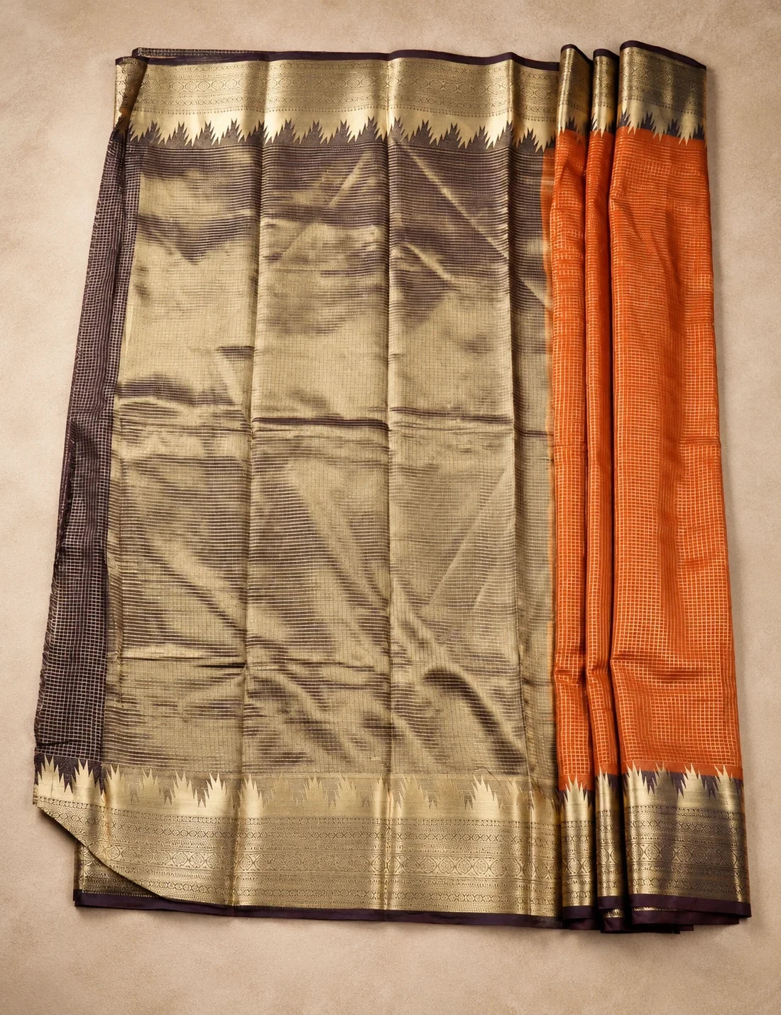 House Of Paramya rust orange Mysore crepe silk saree with a charcoal-brown pallu and gold zari scalloped temple border.