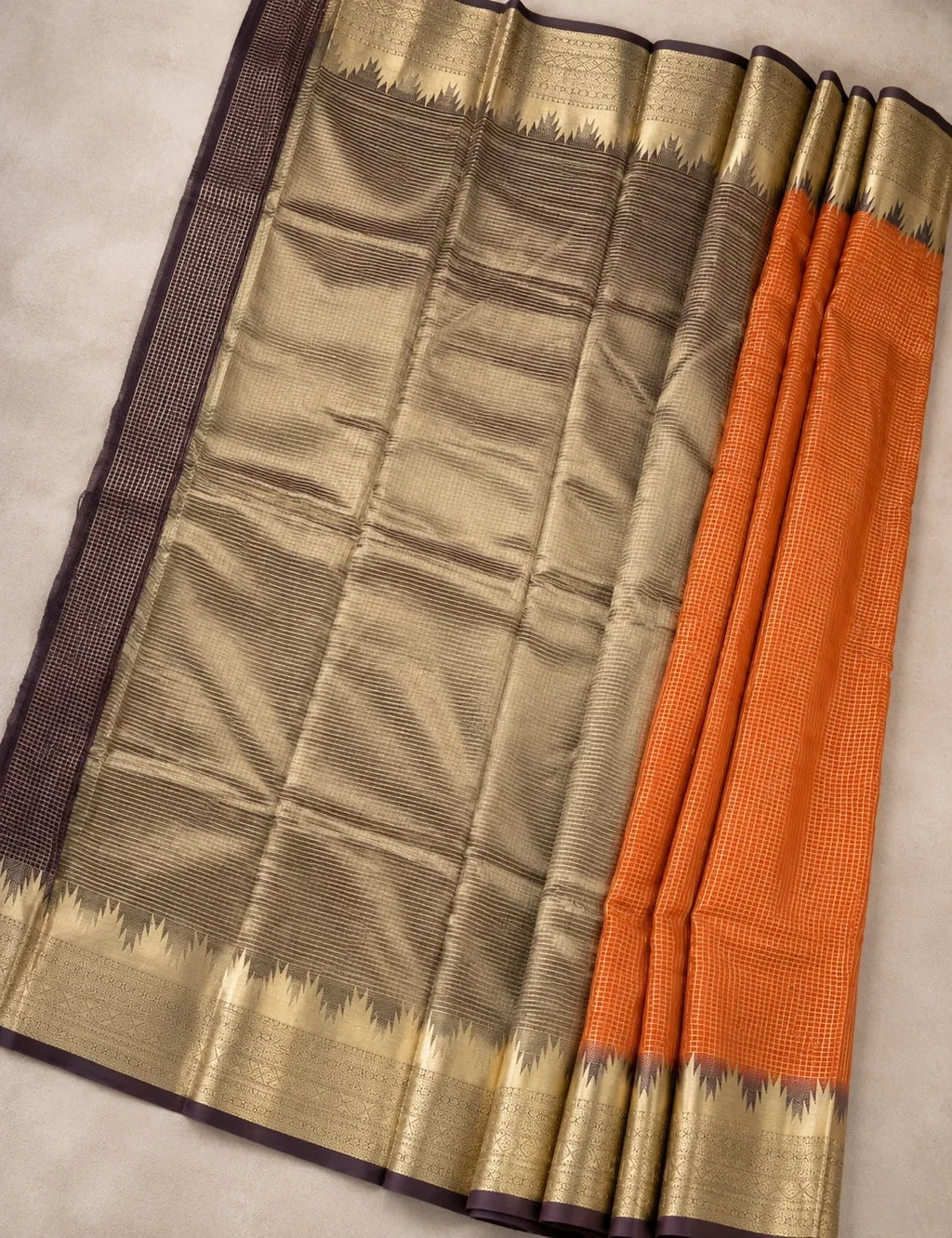 House Of Paramya rust orange Mysore crepe silk saree featuring a charcoal-brown pallu and gold zari temple border.
