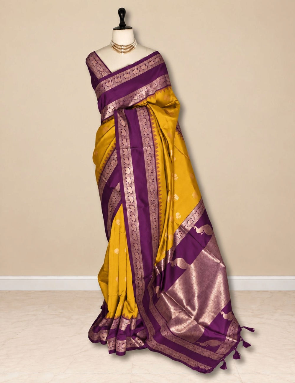 House Of Paramya semi soft silk saree in mustard yellow with a purple elephant border and ornate peacock zari pallu.
