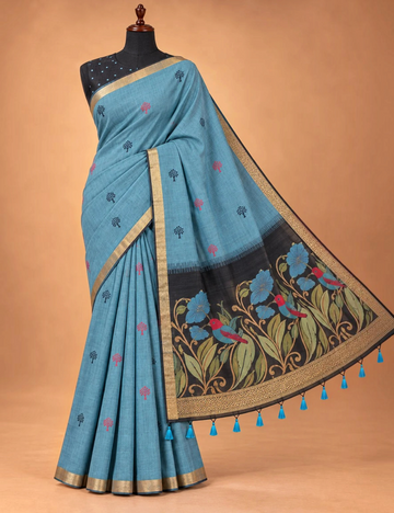 House Of Paramya steel blue Munga cotton saree with tree buttis, charcoal floral pallu, and antique gold zari border.