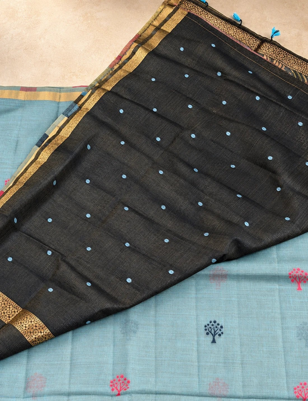 House Of Paramya steel blue Munga cotton saree with navy and pink tree buttis and a charcoal black floral pallu.