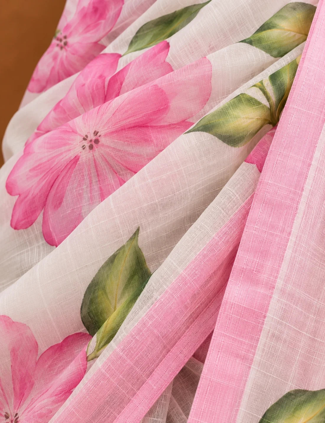 House Of Paramya white linen cotton saree featuring a pink hibiscus floral print and a delicate ombre border.