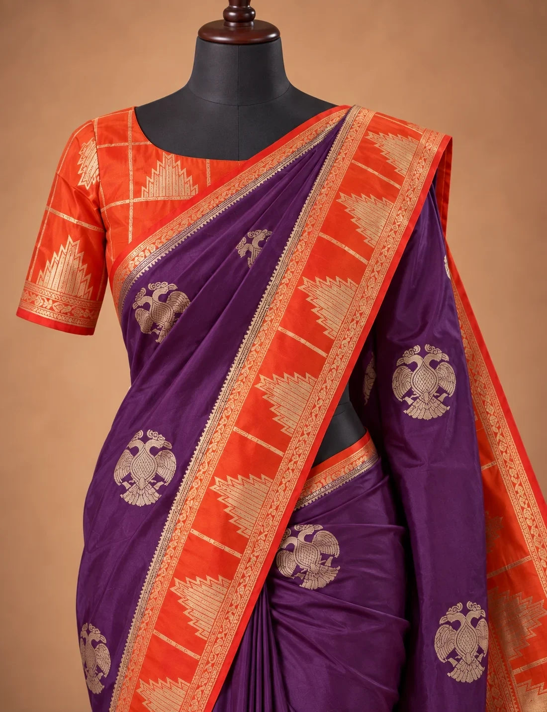 House Of Paramya deep wine Mysore silk saree with gold Gandaberunda motifs and orange temple border on a mannequin.