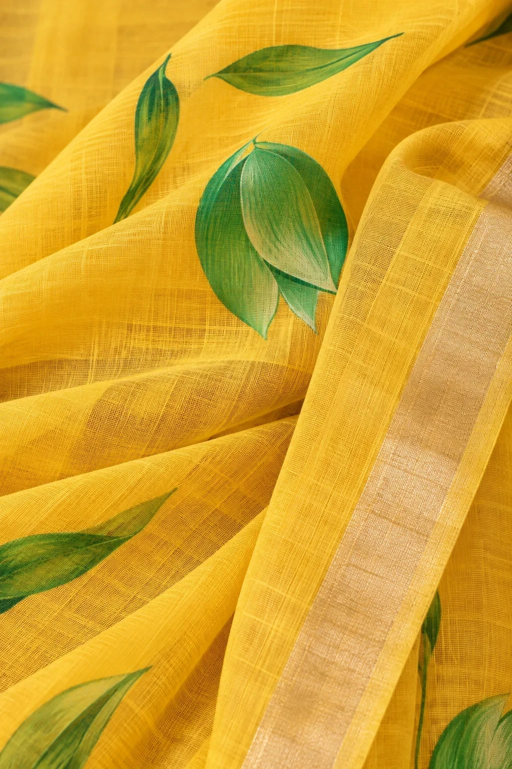 House Of Paramya yellow pure linen saree with green leaf prints and a subtle gold-toned woven border